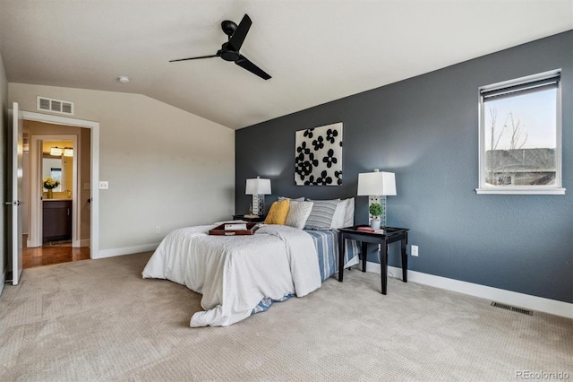 bedroom featuring light carpet, vaulted ceiling, and ceiling fan