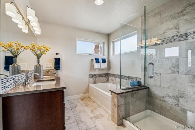 bathroom with vanity, a textured ceiling, tasteful backsplash, and separate shower and tub