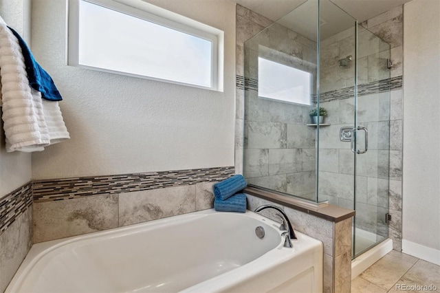 bathroom featuring tile patterned flooring and plus walk in shower