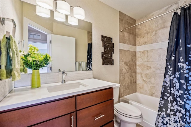 full bathroom with vanity, toilet, and shower / bath combo with shower curtain