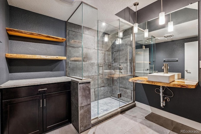 bathroom with tile patterned flooring, a textured ceiling, a shower with shower door, and sink