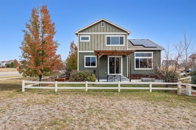 view of front of house with solar panels and a front lawn