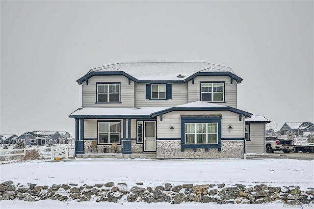 view of front facade featuring stone siding and a porch