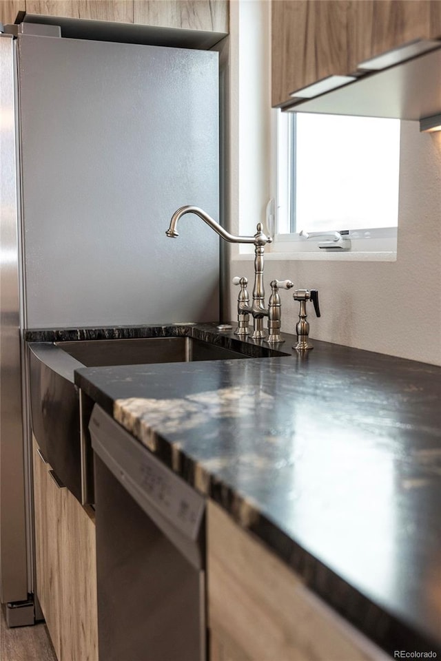 104 Dotson St, Manassa, CO 81141 - kitchen with dishwasher, dark countertops, light brown cabinets, wood finished floors, and modern cabinets