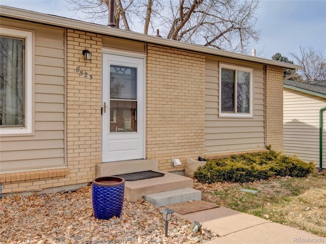 entrance to property with brick siding