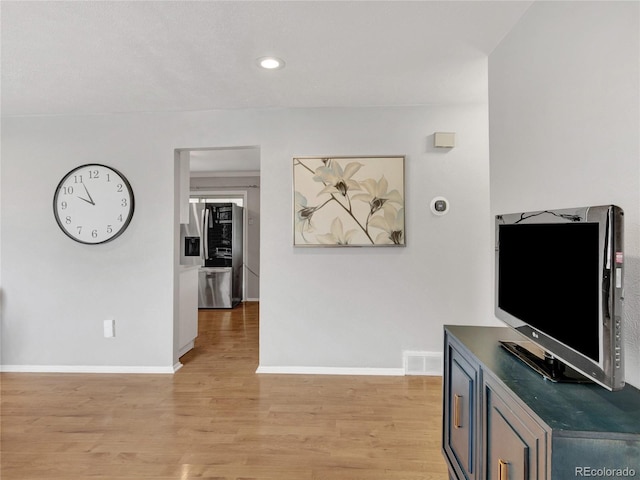 interior space featuring light wood finished floors, visible vents, recessed lighting, and baseboards