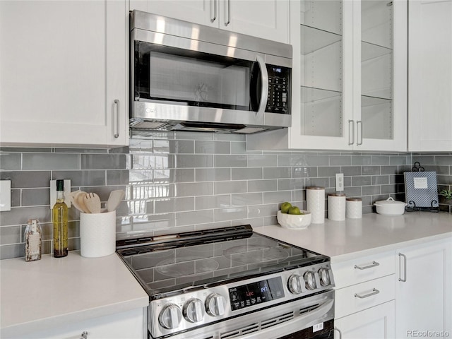 kitchen with white cabinets, stainless steel appliances, and light countertops