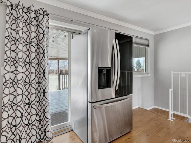 kitchen with crown molding, baseboards, light wood-type flooring, and stainless steel refrigerator with ice dispenser