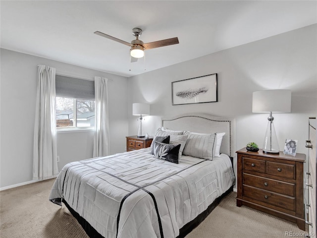 bedroom featuring light colored carpet, baseboards, and ceiling fan