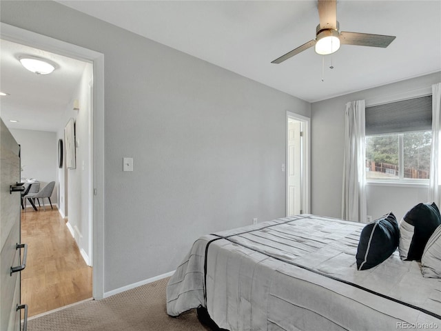 carpeted bedroom featuring ceiling fan and baseboards