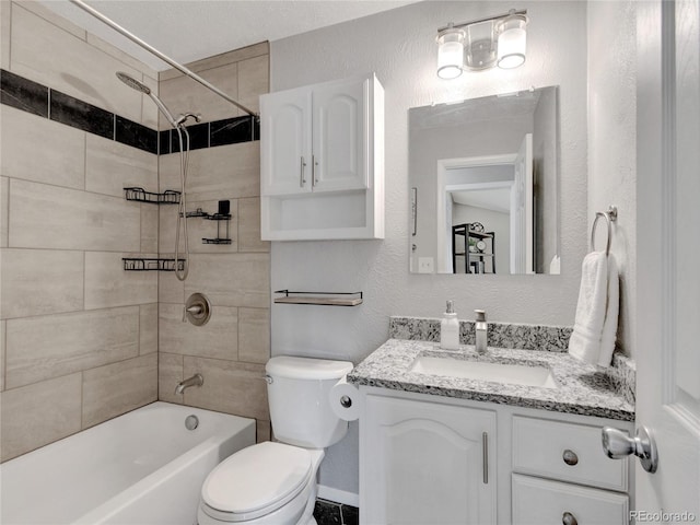 full bath featuring shower / bath combination, toilet, vanity, and a textured wall