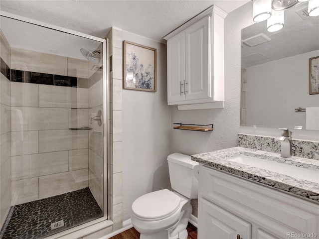 full bath featuring visible vents, toilet, wood finished floors, a shower stall, and vanity