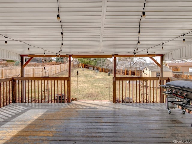 wooden deck with a yard, area for grilling, and a fenced backyard