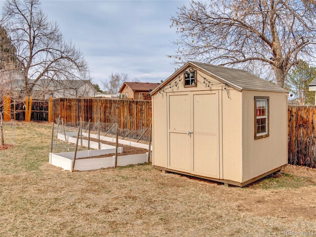 view of shed with a garden and a fenced backyard