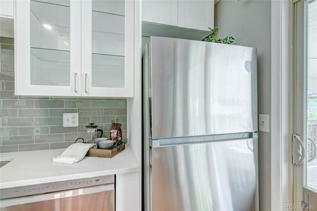 6523 S Field Way, Littleton, CO 80123 - kitchen with appliances with stainless steel finishes, white cabinets, decorative backsplash, and glass insert cabinets