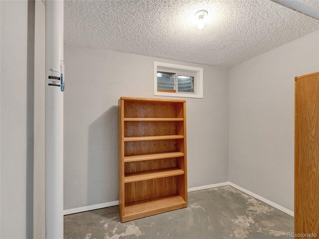 6523 S Field Way, Littleton, CO 80123 - stairs with unfinished concrete flooring, a textured ceiling, and baseboards