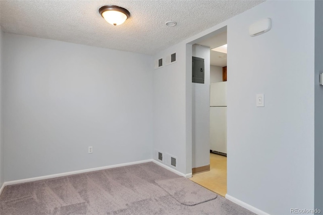 empty room featuring carpet flooring and a textured ceiling