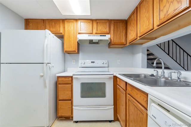 kitchen featuring light tile floors, white appliances, and sink