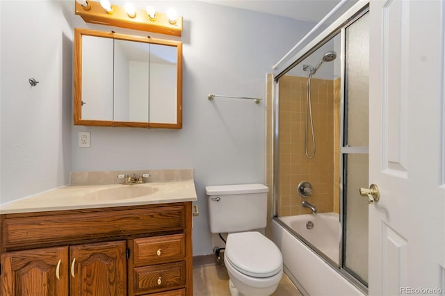 full bathroom with enclosed tub / shower combo, toilet, and vanity