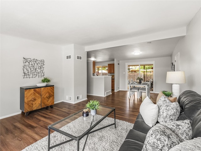 5995 Estes St, Arvada, CO 80004 - living area featuring dark wood-type flooring and baseboards