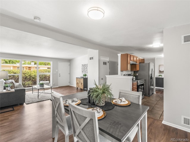 5995 Estes St, Arvada, CO 80004 - dining space with baseboards and dark wood-style flooring