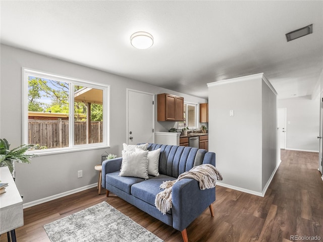 5995 Estes St, Arvada, CO 80004 - living area featuring dark wood-style floors and baseboards