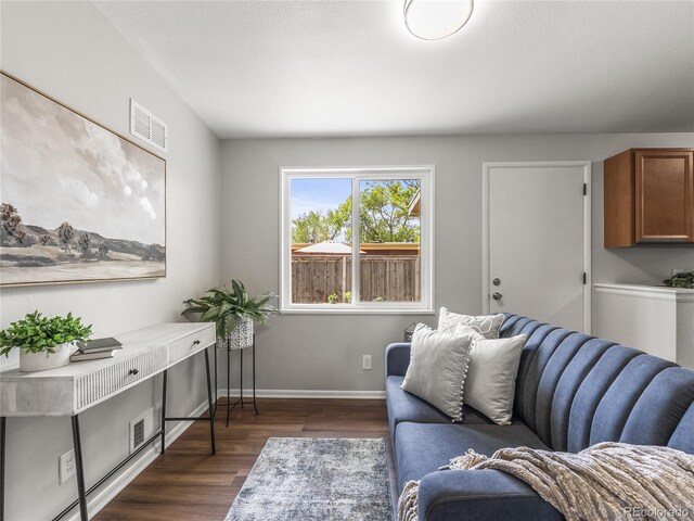 5995 Estes St, Arvada, CO 80004 - living area with dark wood-type flooring and baseboards