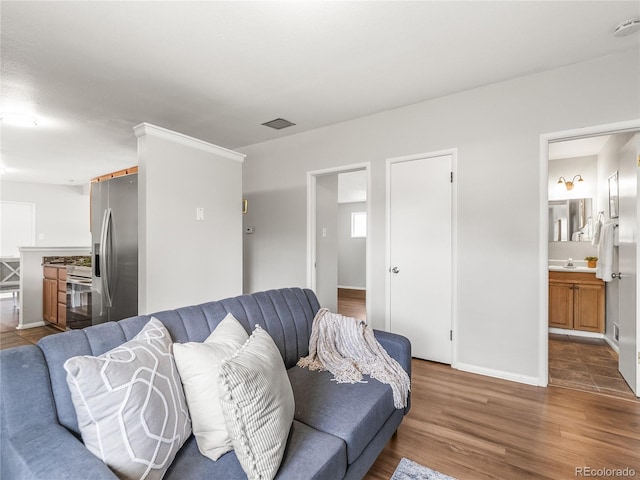 5995 Estes St, Arvada, CO 80004 - living area featuring wood finished floors and baseboards
