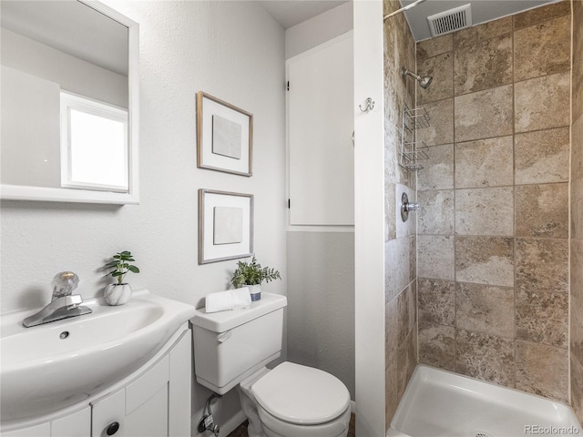 5995 Estes St, Arvada, CO 80004 - full bathroom with toilet, tiled shower, and vanity