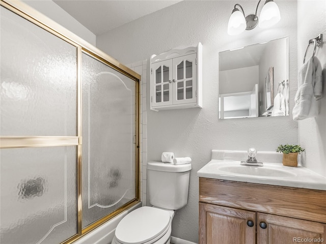 5995 Estes St, Arvada, CO 80004 - full bathroom featuring enclosed tub / shower combo, a textured wall, toilet, and vanity