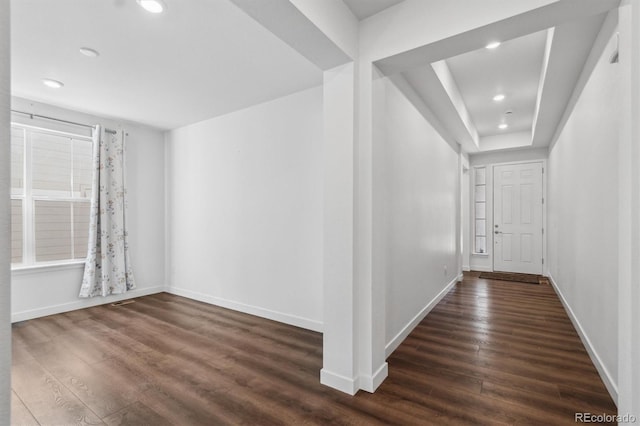 hall with dark wood-type flooring, recessed lighting, and baseboards