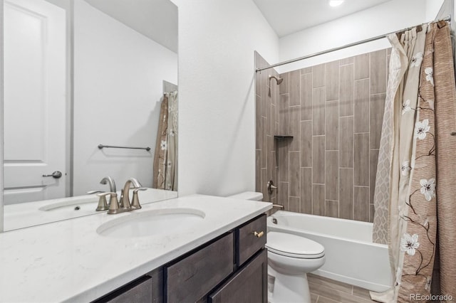 bathroom featuring wood finish floors, shower / tub combo, toilet, and vanity