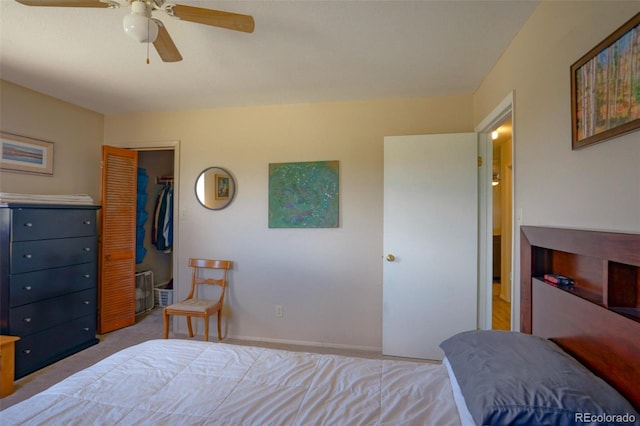 bedroom with a closet, carpet flooring, ceiling fan, and a spacious closet