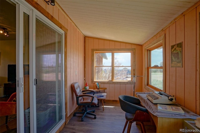 office area featuring wood finished floors, vaulted ceiling, and wood walls