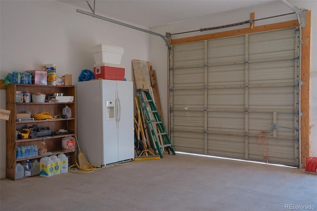 garage featuring white refrigerator with ice dispenser