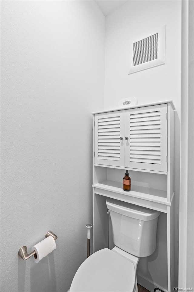 bathroom featuring toilet and visible vents