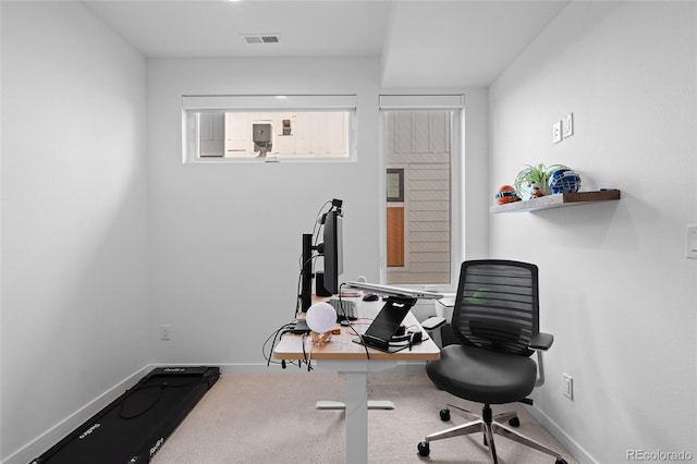 carpeted office with visible vents and baseboards