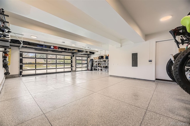 garage featuring electric panel and baseboards