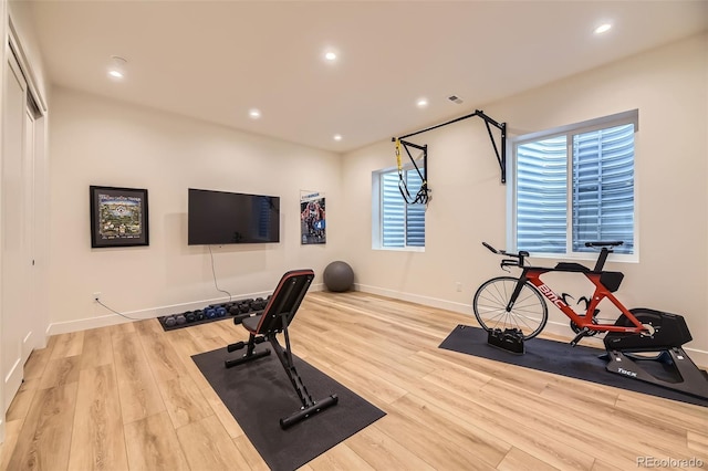 exercise room with recessed lighting, baseboards, and wood finished floors