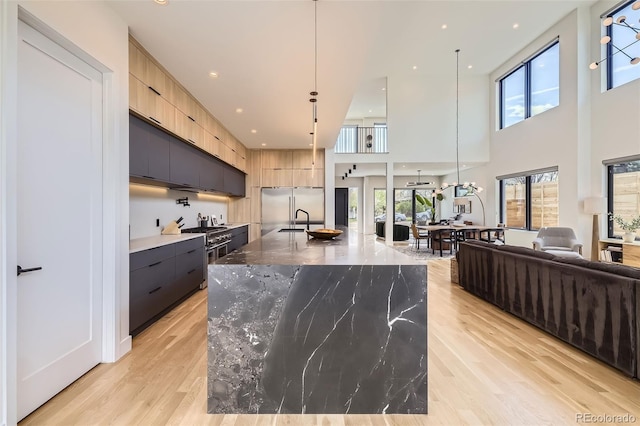 kitchen with plenty of natural light, modern cabinets, a sink, and light brown cabinetry