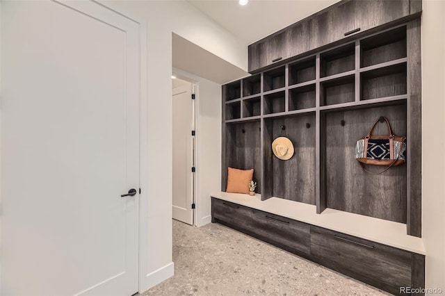 mudroom with baseboards and speckled floor