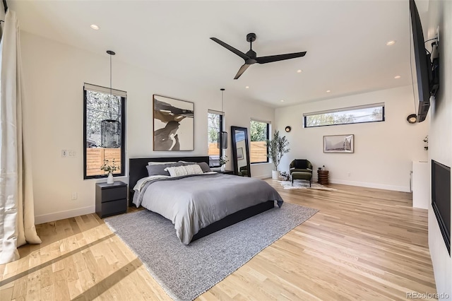 bedroom with baseboards, light wood-type flooring, a ceiling fan, and recessed lighting