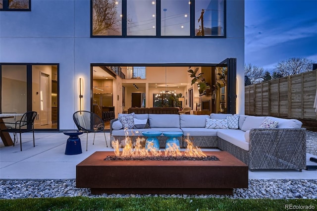 view of patio / terrace featuring an outdoor living space with a fire pit and fence