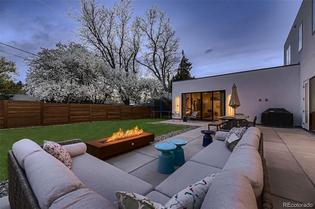 view of patio / terrace featuring an outdoor living space with a fire pit, a trampoline, a grill, and a fenced backyard