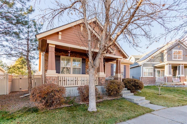 craftsman-style home with covered porch and a front yard