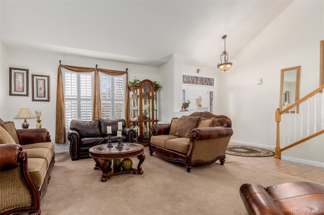 carpeted living room featuring vaulted ceiling