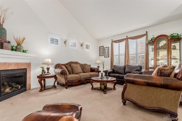 living room with a fireplace, carpet floors, and high vaulted ceiling