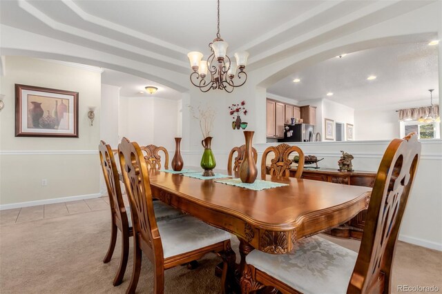 12955 Vallejo Cir, Westminster, CO 80234 - dining space with light colored carpet, a chandelier, recessed lighting, arched walkways, and a tray ceiling