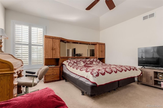 bedroom with ceiling fan, light carpet, and lofted ceiling