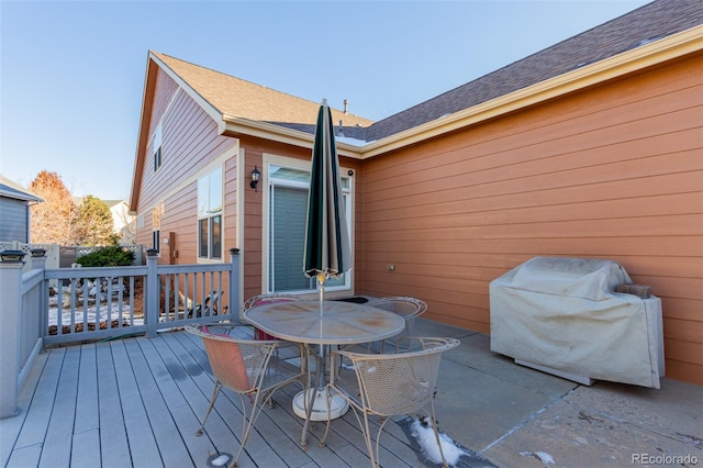 wooden deck featuring a grill